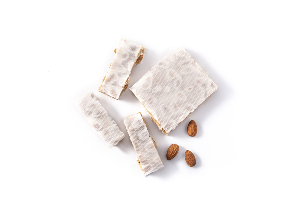Turron de Jijona with almonds on a white background